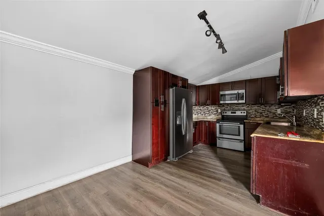 a kitchen with stainless steel appliances granite countertop a refrigerator stove and oven