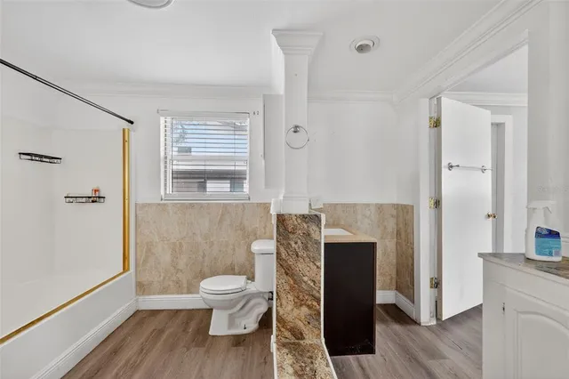 a bathroom with a toilet a sink and shower