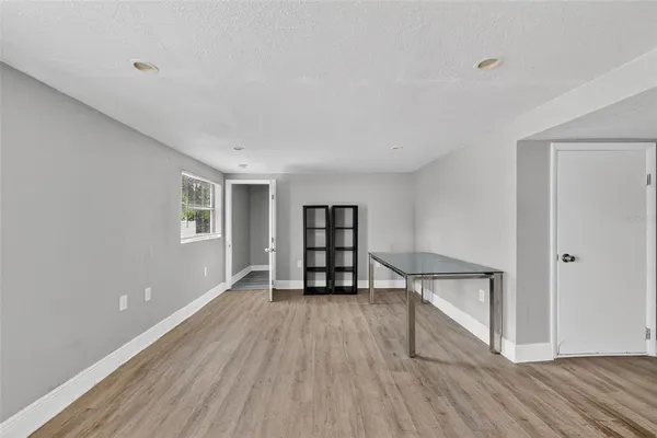 a view of empty room with wooden floor and cabinet