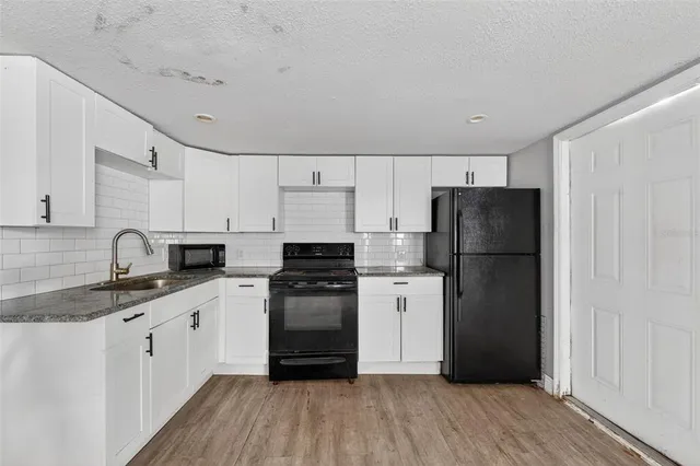 a kitchen with a refrigerator a sink and dishwasher