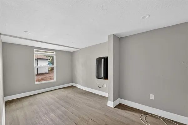 an empty room with windows and closet