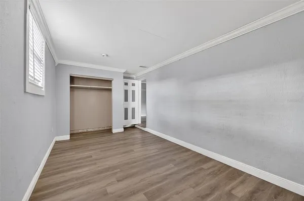 a view of an empty room and wooden floor