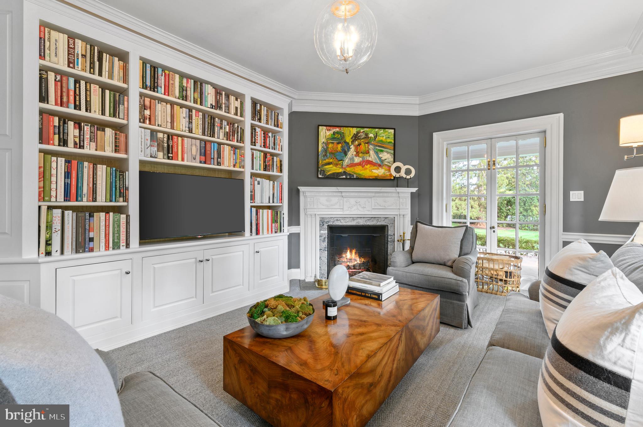 375 North Spring Mill Road Villanova, PA 19085 - Photo 21 of 72 Den with built-ins and doors to side covered porch