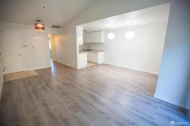 a view of a kitchen with wooden floor
