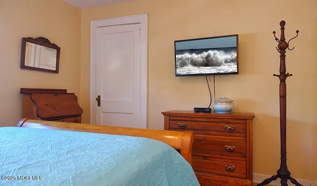 a bedroom with a bed and a dresser