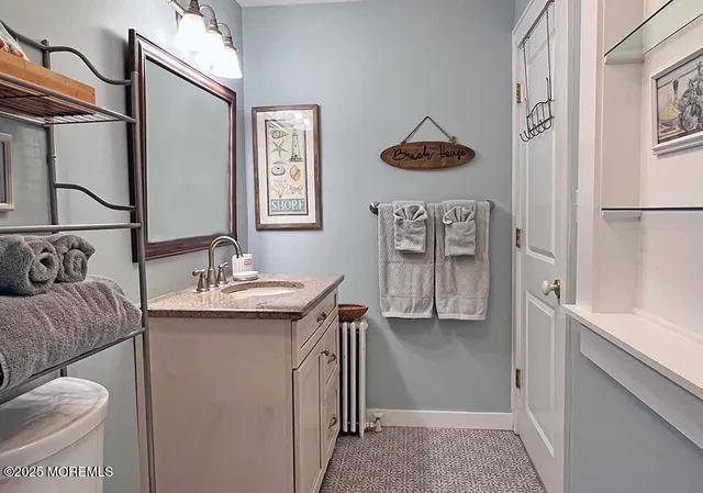 a bathroom with a sink a mirror and a shower