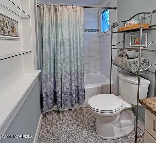 a bathroom with a toilet a sink and tub