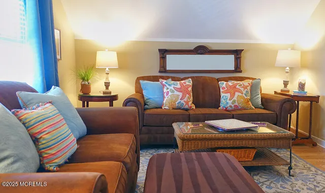 a living room with furniture and a wooden floor