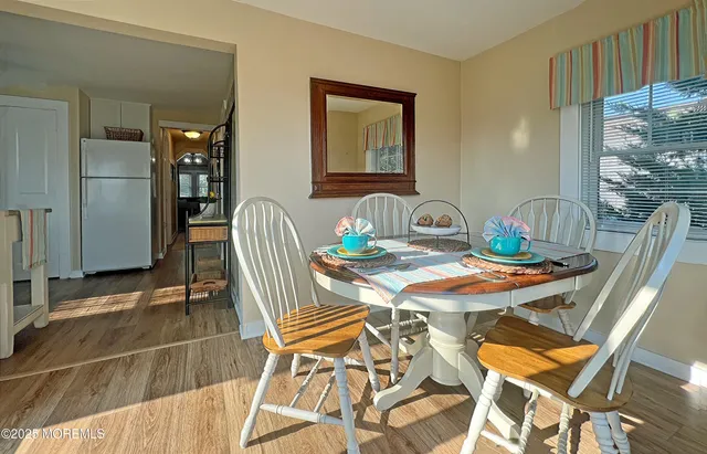 a dining room with furniture and wooden floor
