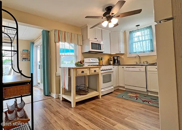 a kitchen with stainless steel appliances a stove a sink and a refrigerator