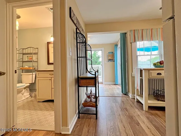 a view of a hallway view with wooden floor and staircase