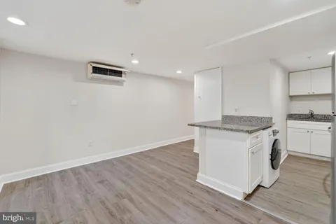 a kitchen with stainless steel appliances granite countertop a refrigerator a stove a sink and a microwave