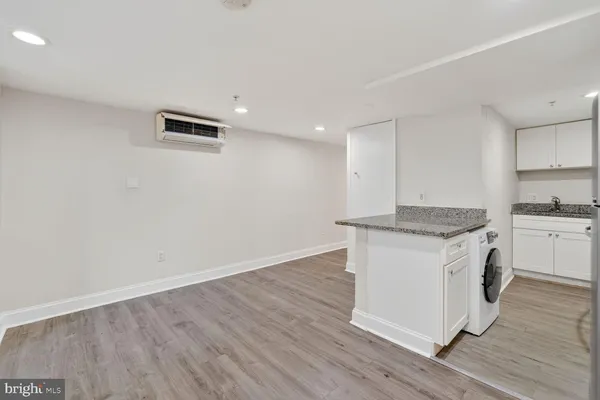 a kitchen with stainless steel appliances granite countertop a refrigerator a stove a sink and a microwave