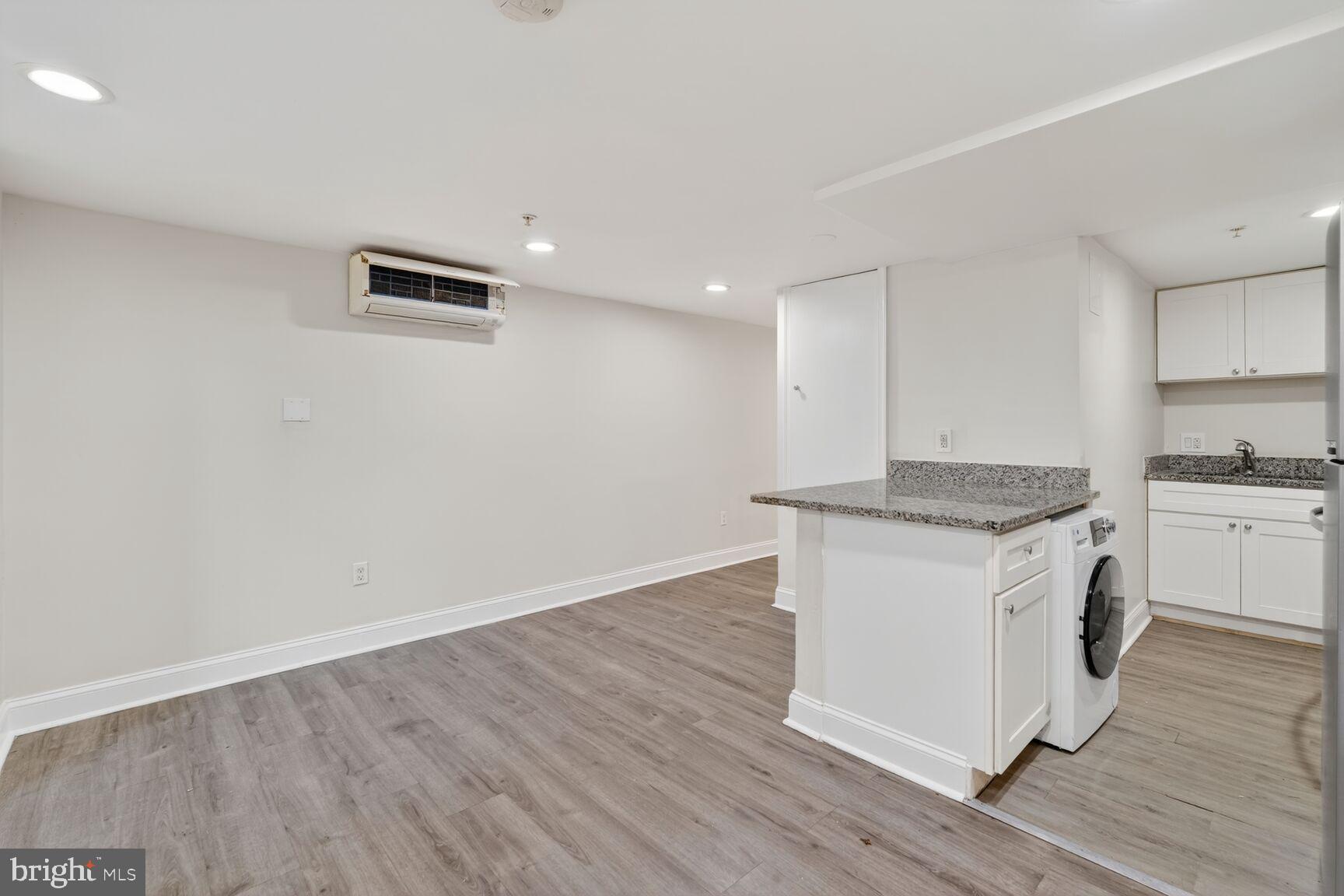 113 15th Street Southeast Washington, DC 20003 - Photo 17 of 27 a kitchen with granite countertop a sink and a stove top oven