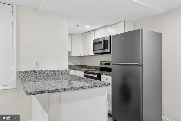 a kitchen with a stove and a microwave