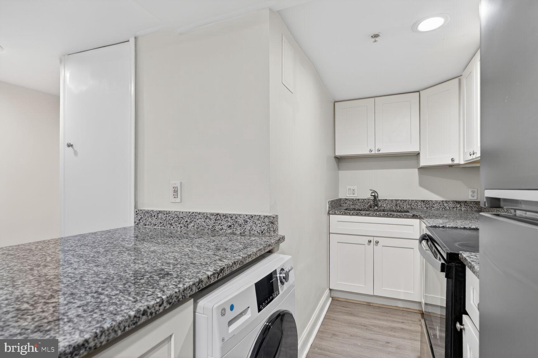 113 15th Street Southeast Washington, DC 20003 - Photo 20 of 27 a kitchen with a sink stove and cabinets