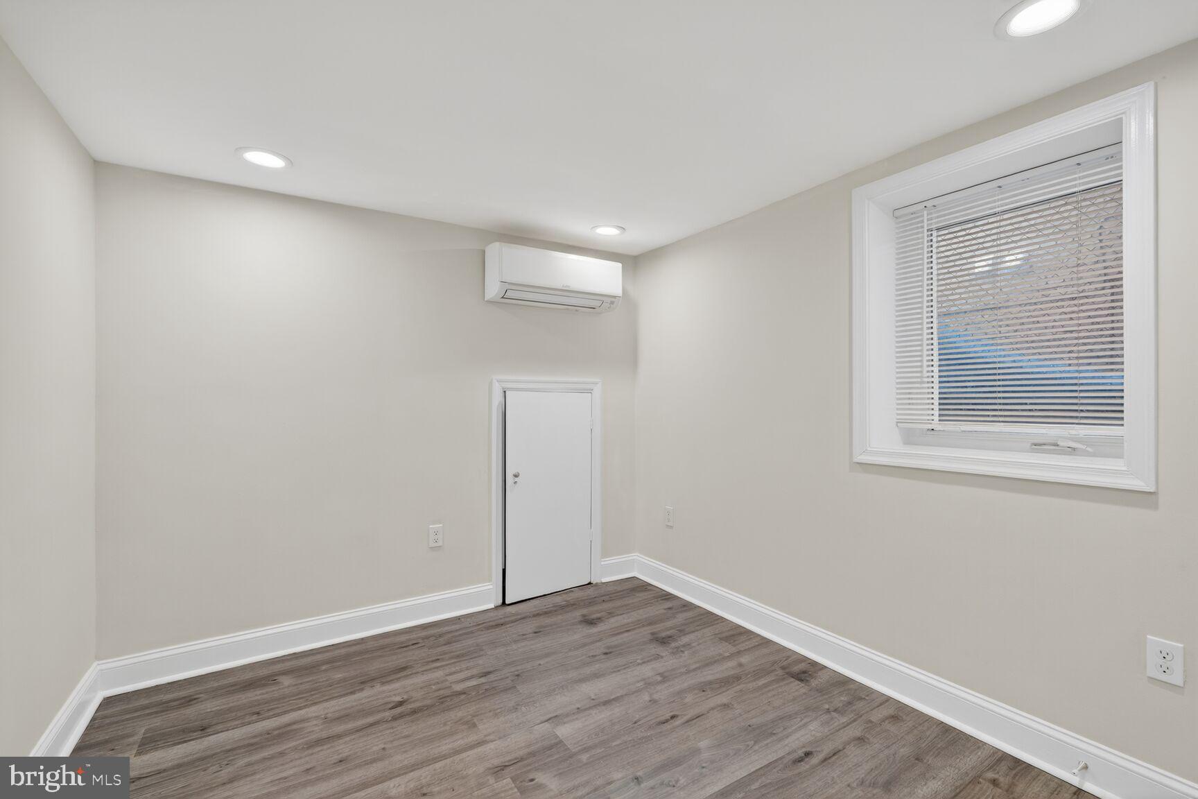 113 15th Street Southeast Washington, DC 20003 - Photo 23 of 27 a view of an empty room with wooden floor and a window