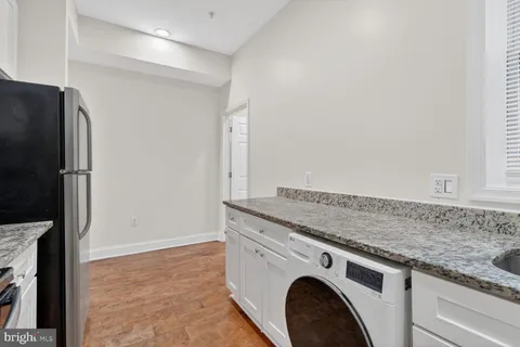 a bathroom with a sink toilet and a mirror