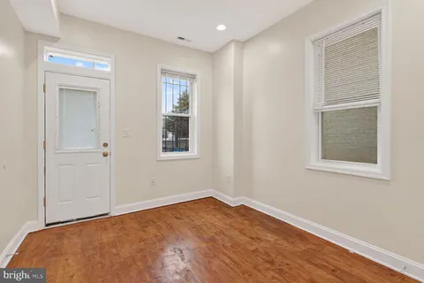 a bathroom with a granite countertop double vanity sink and a mirror