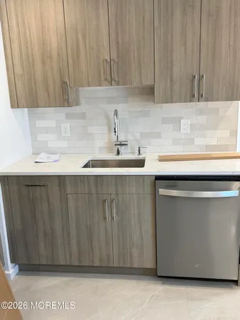 a kitchen with a sink cabinets and a window