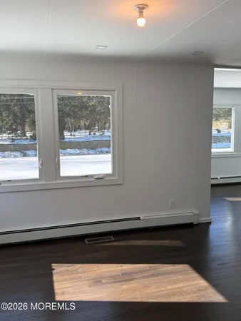 a view of kitchen cabinets and wooden floor