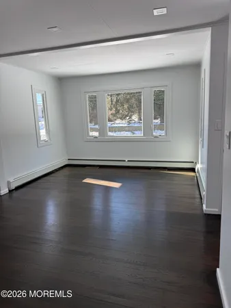 a view of a room with wooden floor and window
