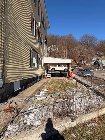 a yellow house with trees in front of it