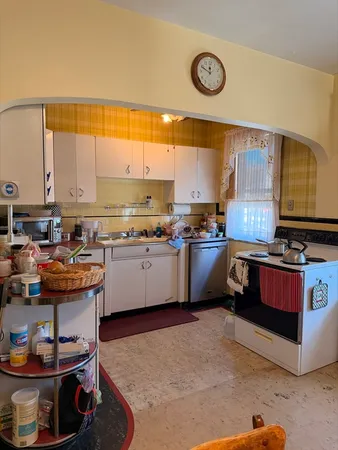 a kitchen with a stove a sink and a refrigerator
