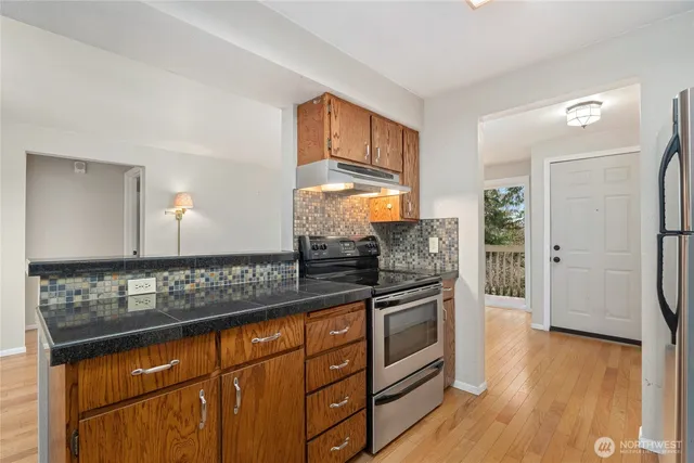a view of a kitchen counter space and wooden floor