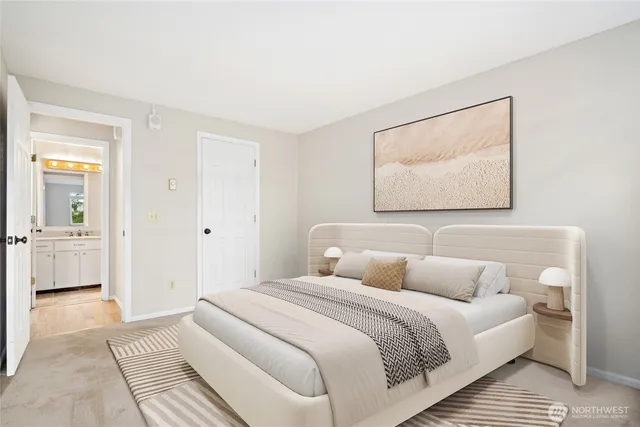 a bedroom with a bed and a painting on the wall