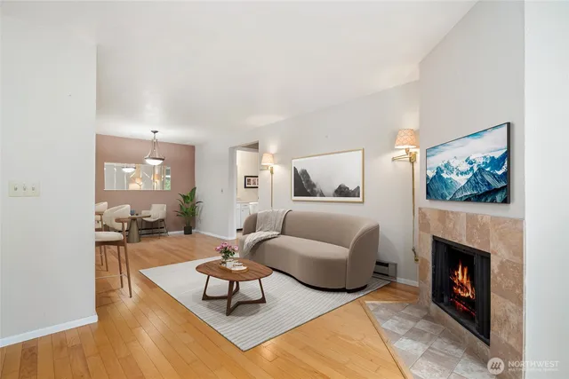 a living room with furniture a flat screen tv and a fireplace