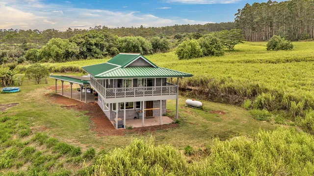 a view of a house with a yard and sitting area