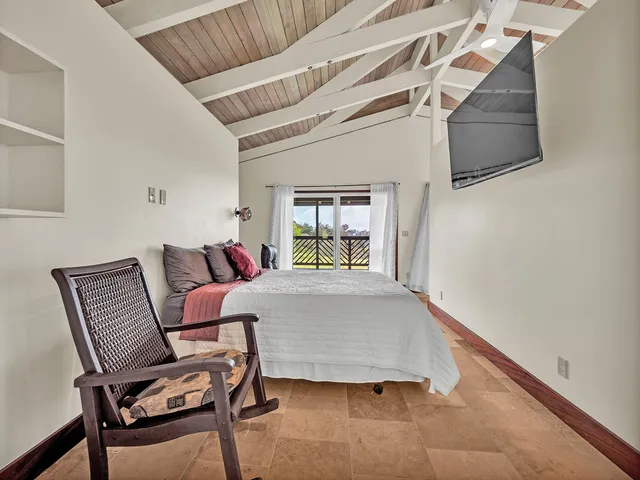 a bedroom with a bed and a chair