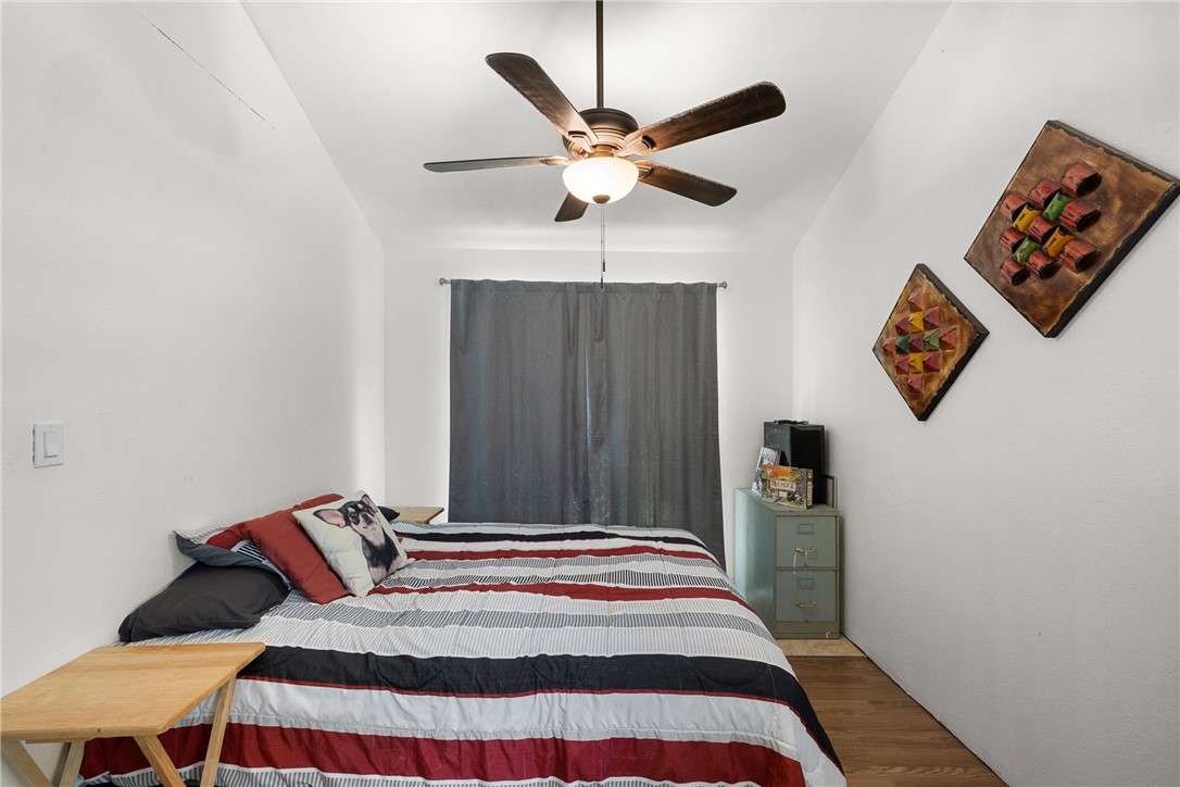 12255 County Road Centerville, TX 75833 - Photo 12 of 26 a bedroom with a bed and a chandelier