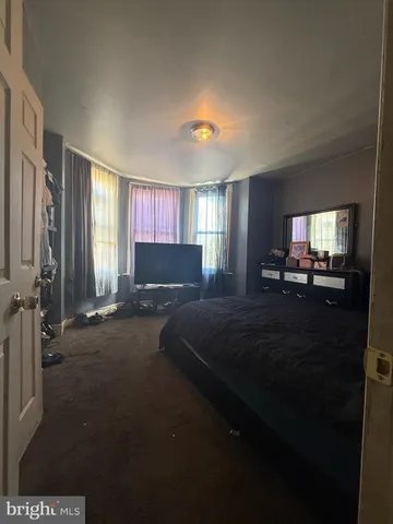 a bedroom with a bed and a lamp on table