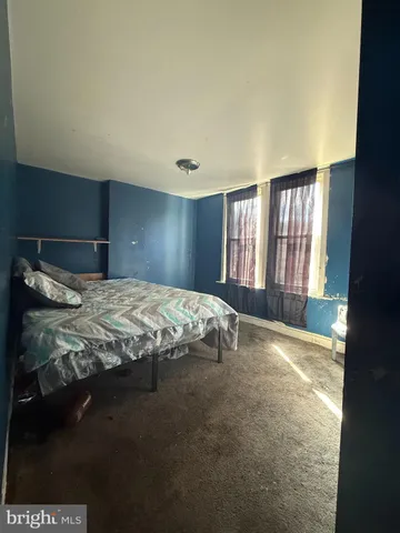 a bedroom with a bed and a night stand