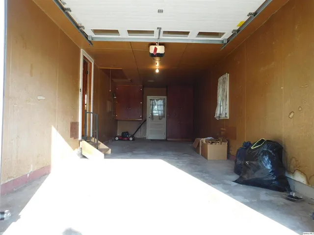 a view of a living room with furniture and a chandelier