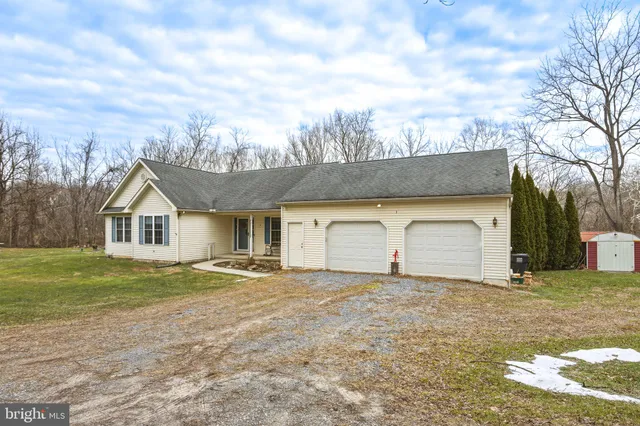 a front view of house with yard and trees