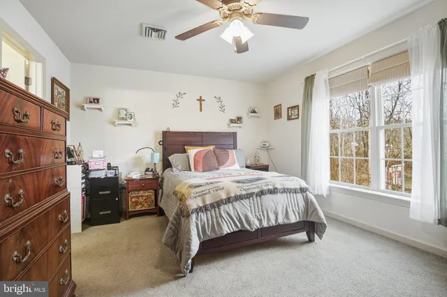 a bedroom with a bed and flat screen tv