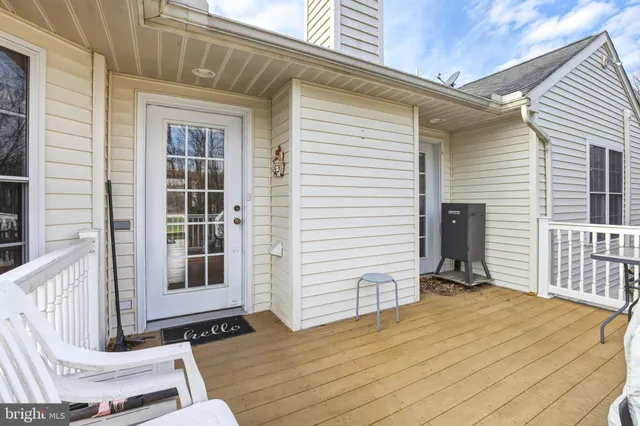 a view of balcony with wooden floor and outdoor seating