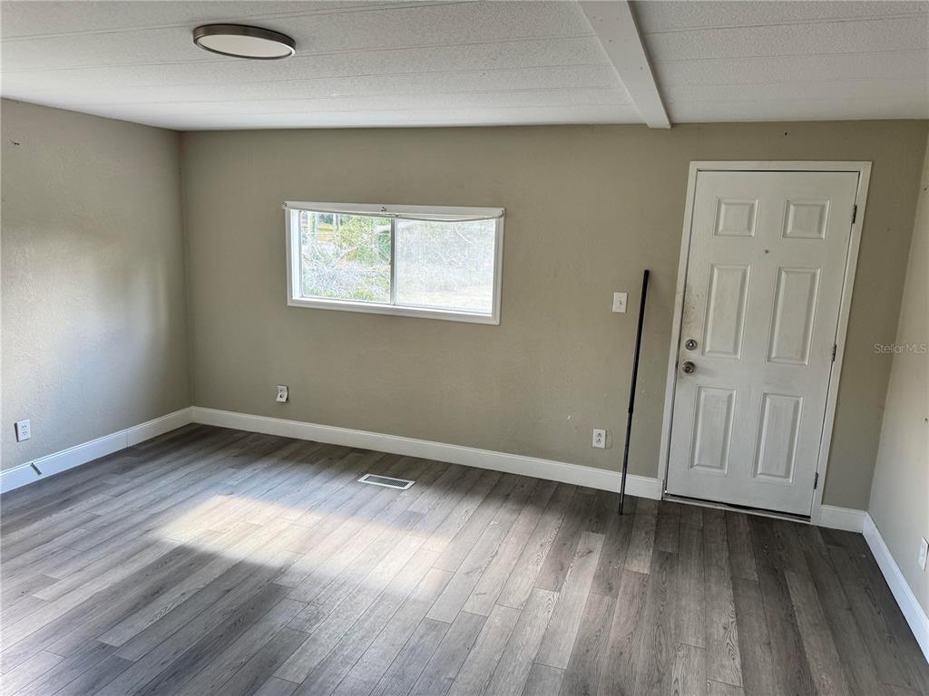 3402 Pearson Road Valrico, FL 33596 - Photo 15 of 24 an empty room with wooden floor and windows