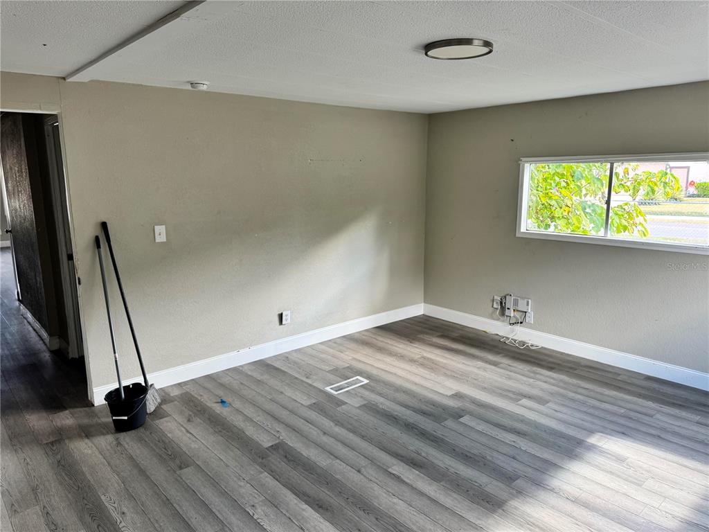 3402 Pearson Road Valrico, FL 33596 - Photo 16 of 24 an empty room with wooden floor and a window