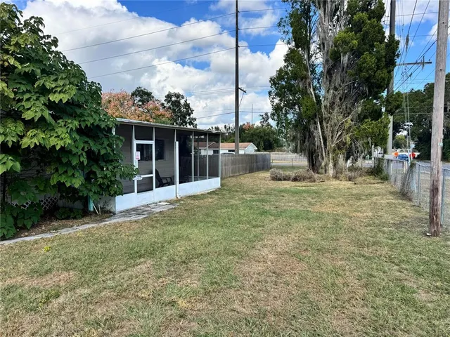 a view of a house with backyard and sitting area