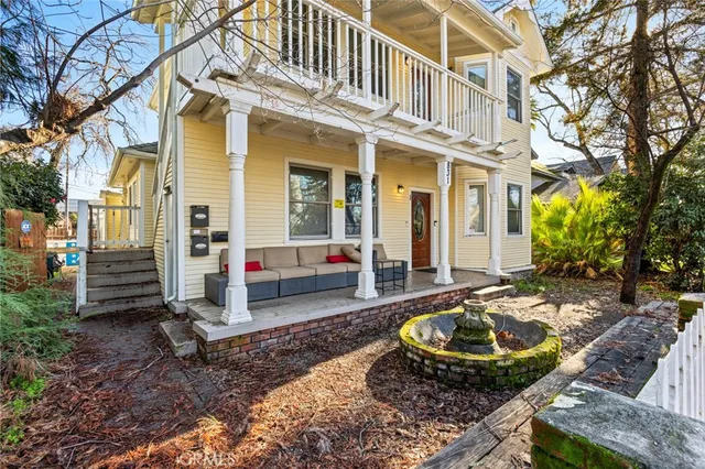 a view of a house with backyard and sitting area