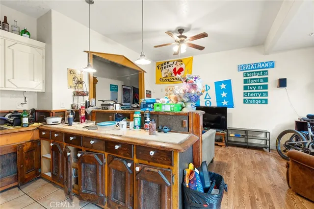 a kitchen that has a lot of cabinets a sink and a stove in it