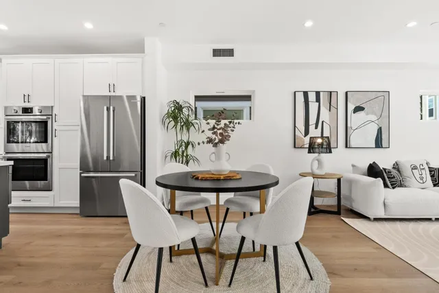 a kitchen with stainless steel appliances granite countertop a sink a stove and a refrigerator