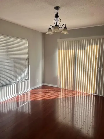 a view of a livingroom with wooden floor and a window