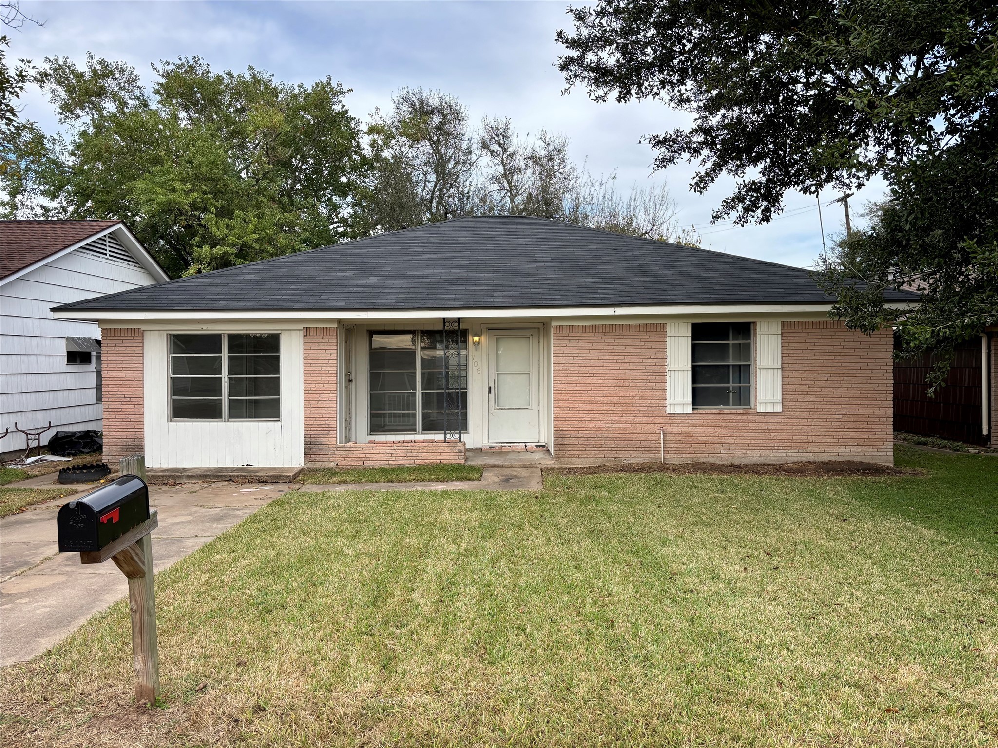 706 West 7th Street Freeport, TX 77541 - Photo 1 of 22 a front view of a house with a garden and yard