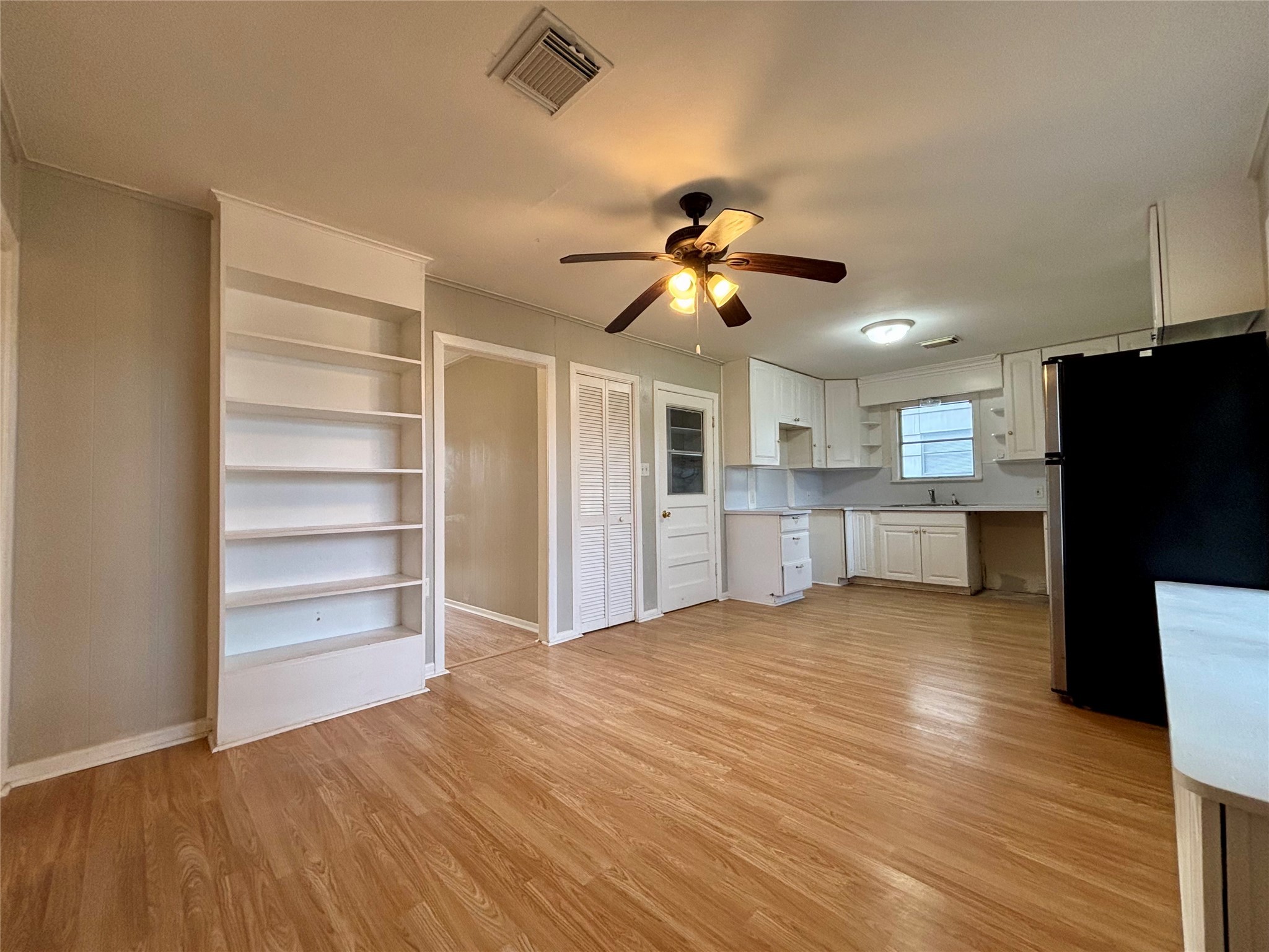 706 West 7th Street Freeport, TX 77541 - Photo 14 of 22 a view of a kitchen with a microwave and a ceiling fan