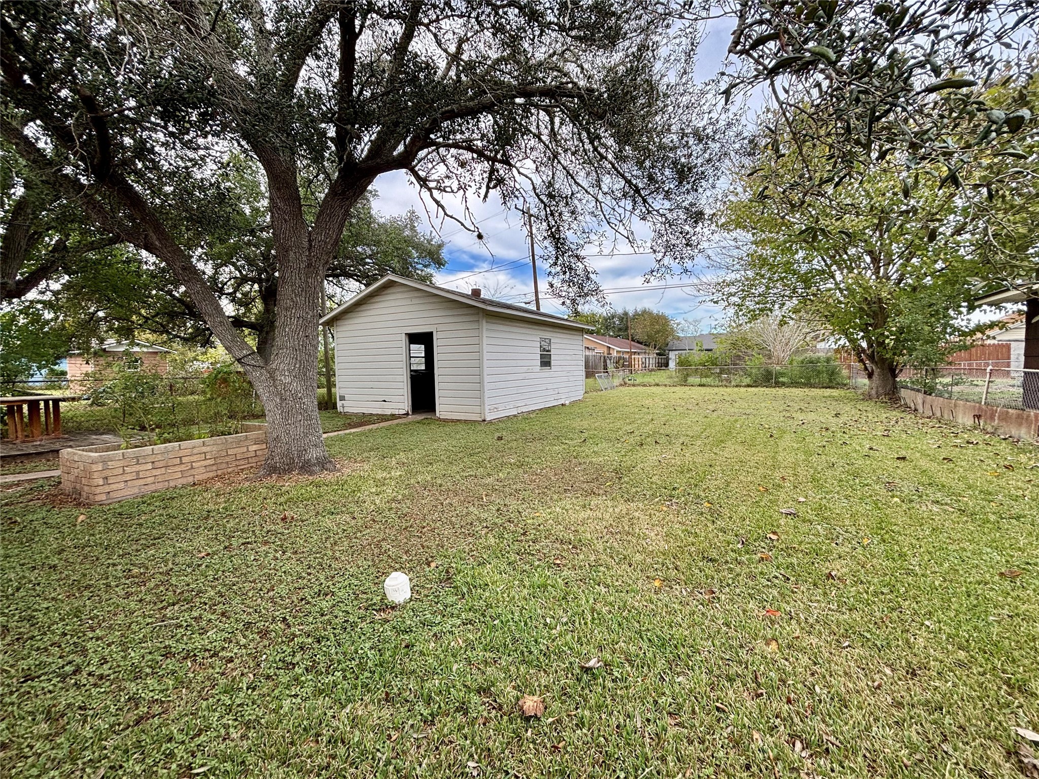 706 West 7th Street Freeport, TX 77541 - Photo 20 of 22 a white house that has a tree in front of it